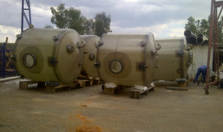 Four fibreglass storage tanks.