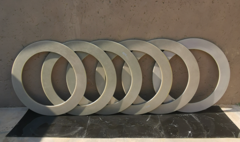 Eight fibreglass rings lined up against a wall
