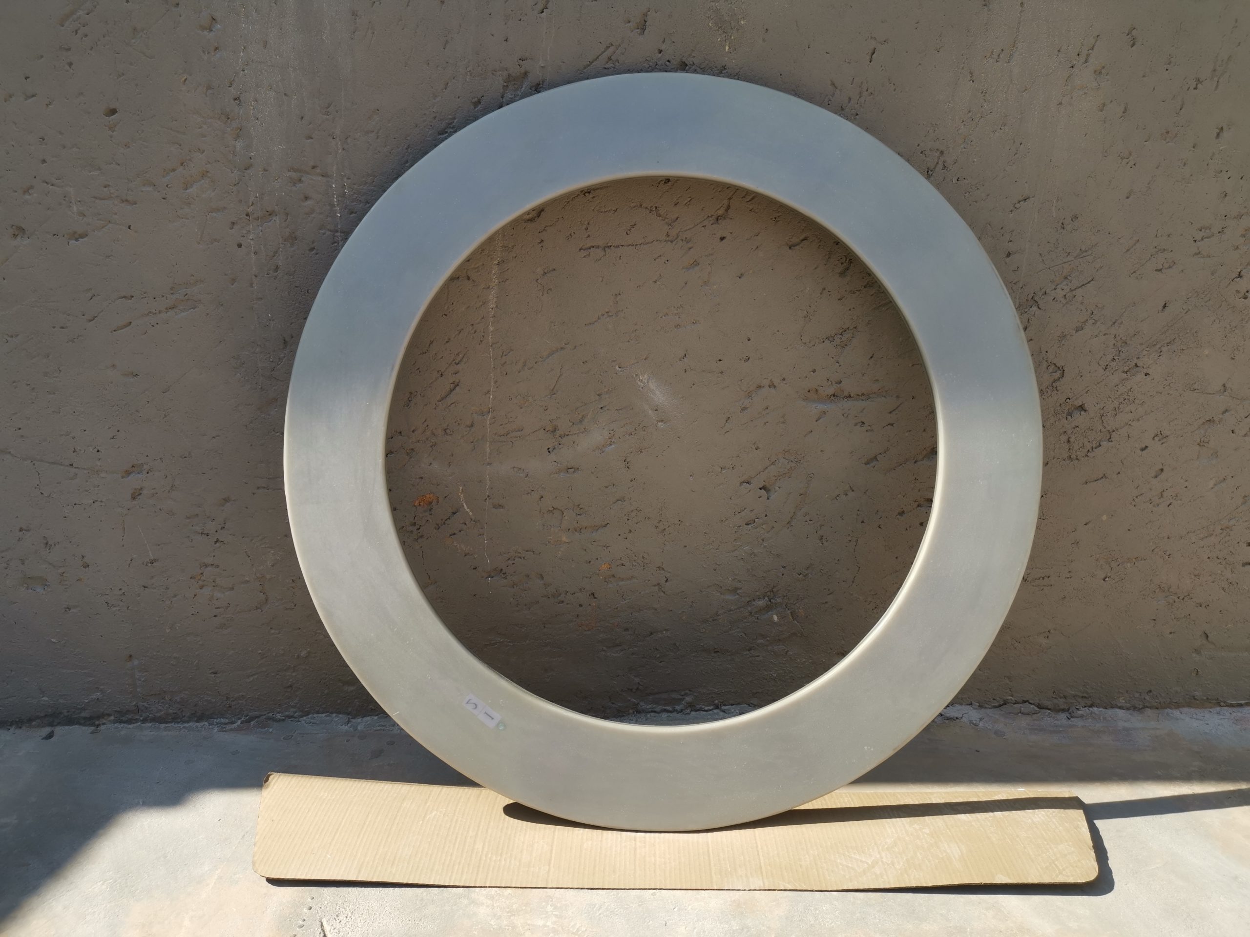 One flame retardant fibreglass ring leaning against a wall