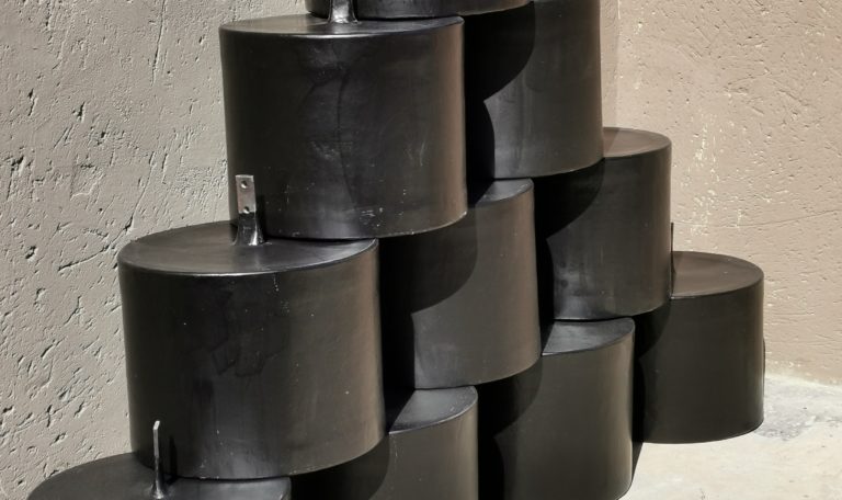 large fibreglass barrels stacked in a pyramid shape